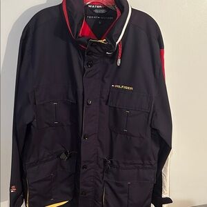 Tommy Hilfiger Men's Black coat , zipper to tuck hood away with Red Accents